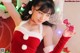 A woman in a red and white dress holding a candy cane.