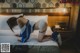 A woman laying on a bed in a hotel room.