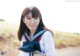 A woman in a school uniform posing for a picture.