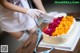 A woman cutting a birthday cake with a knife.