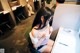 A woman sitting at a desk in front of a computer.